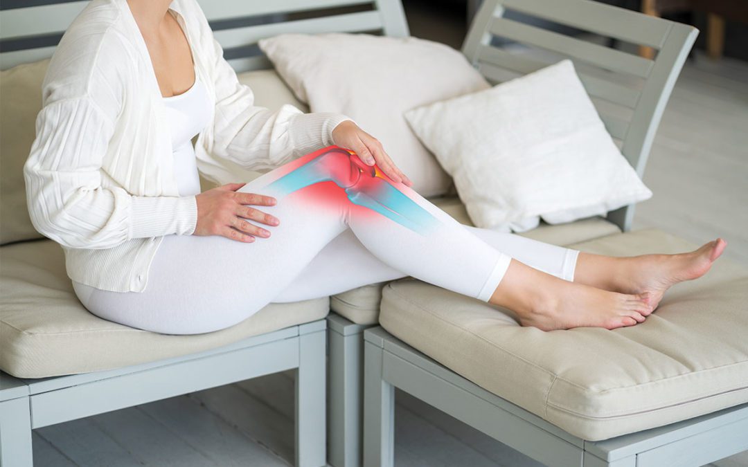 woman sitting on couch with knee pain